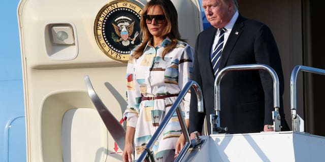 U.S. President Donald Trump, right, and first lady Melania Trump arrive at the Haneda International Airport Saturday, May 25, 2019, in Tokyo. (Associated Press)