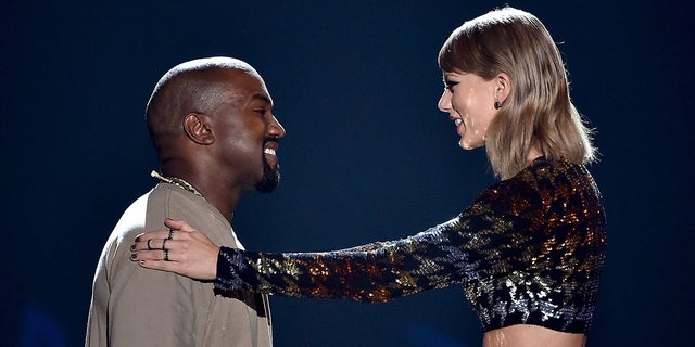 Performer Kanye West accepts the Video Vanguard Award from performer Taylor Swift at the MTV Video Music Awards 2015 at the Microsoft Theater on August 30, 2015 in Los Angeles. (Photo by Kevin Winter / MTV1415 / Getty Images for MTV)