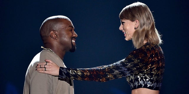 Recording artist Kanye West accepts the Video Vanguard Award from recording artist Taylor Swift onstage during the 2015 MTV Video Music Awards at Microsoft Theater on August 30, 2015 in Los Angeles. (Photo by Kevin Winter/MTV1415/Getty Images For MTV)