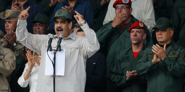 FILE - In this April 13, 2019 file photo, Venezuela's President Nicolas Maduro, speaks flanked by Defense Minister Vladimir Padrino Lopez, right, and Gen. Ivan Hernandez, second from right, head of both the presidential guard and military counterintelligence in Caracas, Venezuela. The Associated Press has learned that at least twice since 2016, the U.S. government missed chances to cultivate relations with regime insiders, including Padrino and Hernández, who National Security Adviser John Bolton said backed out of a plan to topple Maduro. (AP Photo/Ariana Cubillos, File)