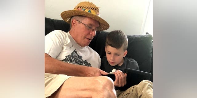 This summer 2018, a photo provided by Al Mattin on Friday, May 10, 2019 shows his father, Stephen, and his son, Ronan, at Stephen's home in Kensington, N.H. The Handel & amp; Haydn Society had just finished an interpretation of Mozart 