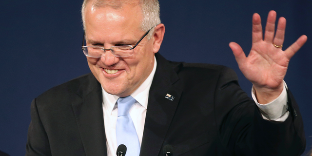 Australian Prime Minister Scott Morrison speaks to party supporters after his opponent concedes defeat in the federal election in Sydney, Australia, Sunday, May 19, 2019. Australia's ruling conservative coalition, lead by Morrison, won a surprise victory in the country's general election, defying opinion polls that had tipped the center-left opposition party to oust it from power and promising an end to the revolving door of national leaders. (AP Photo/Rick Rycroft)