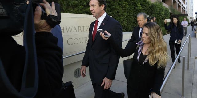 In this photo, on Dec. 3, 2018, the Republican representative Duncan Hunter, center, left the San Diego court