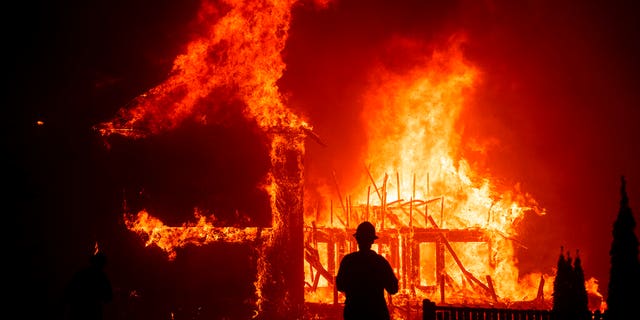 A home burns as the Camp Fire rages through Paradise, Calif,. on Nov. 8, 2018. (AP Photo/Noah Berger,File)