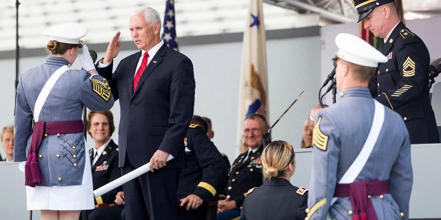 Vice President Mike Pence salutes a graduating cadet before handing a diploma to her during graduation ceremonies at the United States Military Academy, Saturday, May 25, 2019, in West Point, N.Y. (AP Photo/Julius Constantine Motal)