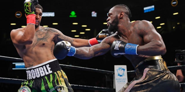 Dominic Breazeale, left, evades a right from Deontay Wilder during the first round of the WBC heavyweight championship boxing match Saturday, May 18, 2019, in New York. Wilder won in the first round.