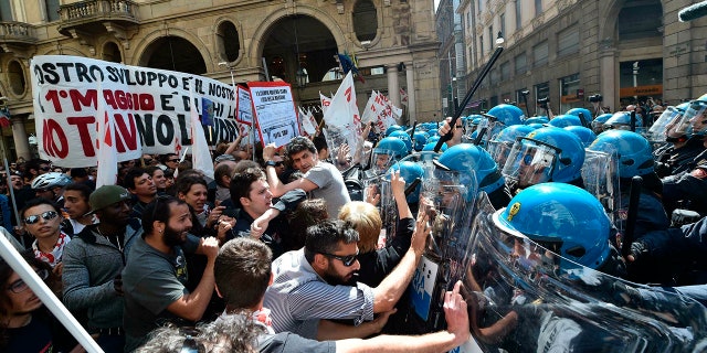 Protesters confront police officers when riots broke out on Wednesday, May 1, 2019, during a rally on May 1 in Turin, Italy.
