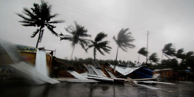 Street shops are seen collapsed due to gusty winds preceding the landfall of cyclone Fani on the outskirts of Puri, in the Indian state of Odisha. (AP Photo)