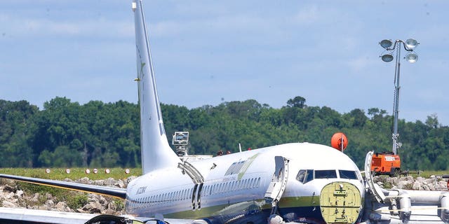 A charter plane carrying 143 people and traveling from Cuba to north Florida sits in a river at the end of a runway, Saturday, May 4, 2019 in Jacksonville, Fla.
