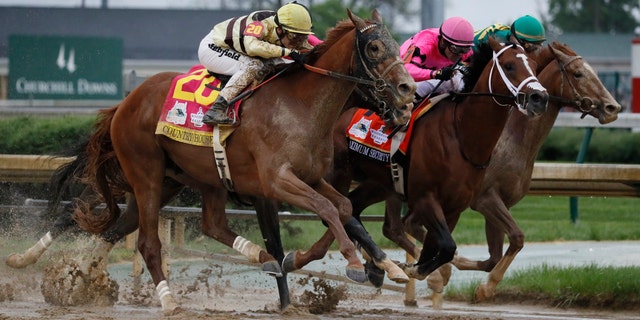 In a historical reversal, Country House, left, was declared the winner of the 145th running of the Kentucky Derby at Churchill Downs on Saturday following “an inquiry ruling” and the disqualification of Maximum Security, center, officials said.