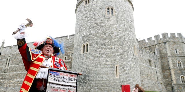 An unofficial Town Crier announces the birth of a baby boy born to Britain's Prince Harry and Meghan, the Duchess of Sussex, outside Windsor Castle in Windsor, south England, Monday May 6, 2019, after Prince Harry announced that his wife Meghan, Duchess of Sussex, has given birth to a boy.