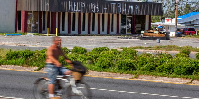 FILE: A cyclist rides by a building damaged by Hurricane Michael in Parker, Fla. Residents in these parts of the Florida Panhandle that were devastated by Hurricane Michael six months ago. (Associated Press)