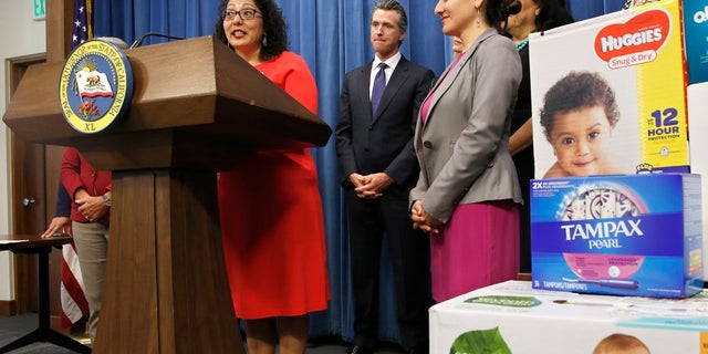 Assemblywoman Cristina Garcia discusses the proposal by Gov. Gavin Newsom, second from left, to eliminate the state sales tax on tampons and diapers in his upcoming state budget during a news conference Tuesday. (Associated Press)
