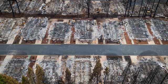 This Dec. 3 photo shows homes leveled by the Camp Fire line the Ridgewood Mobile Home Park retirement community in Paradise, Calif. (AP Photo/Noah Berger, File)