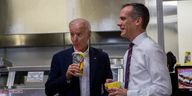 Democratic presidential candidate Joe Biden, left, visits a King Taco restaurant with Los Angeles Mayor Eric Garcetti on Wednesday. (Associated Press)