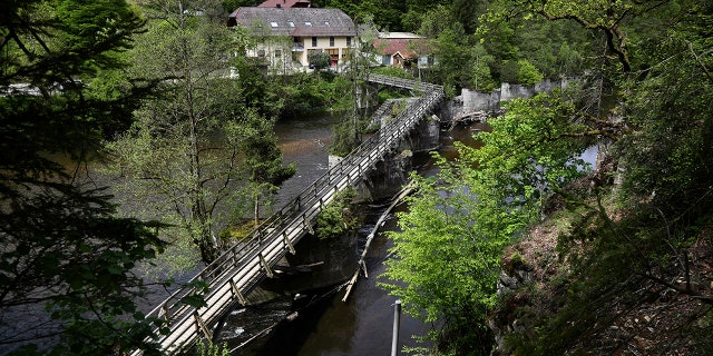 A guesthouse is pictured at the river 'Ilz' in Passau, Germany, Monday, May 13, 2019. Police investigating the mysterious death of three people whose bodies were found with crossbow bolts inside at the hotel in Bavaria on Saturday, May 11, 2019. (AP Photo/Matthias Schrader)