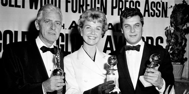 In this Feb. 26, 1958 file photo, actress Doris Day, center, Tony Curtis, right, and Buddy Adler pose with their awards presented to them by the Hollywood Foreign Press Association at its annual awards dinner in the Cocoanut Grove in Los Angeles. — AP