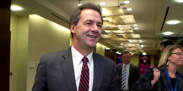 FILE -In this Feb. 23, 2019, file photo, Montana Gov. Steve Bullock walks to a meeting during the National Governors Association 2019 winter meeting in Washington. (AP Photo/Jose Luis Magana, File)