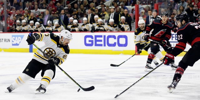 Boston Bruins' Brad Marchand (63) controls the puck against Carolina Hurricanes' Brett Pesce (22) during the first period in Game 3 of the NHL hockey Stanley Cup Eastern Conference final series in Raleigh, N.C., Tuesday, May 14, 2019. (Associated Press)