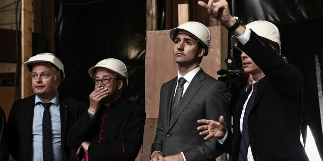 Canadian Prime Minister Justin Trudeau, third left, French Culture Minister Franck Riester, right, Notre Dame cathedral rector Patrick Chauvet, second left, and French chief architect of Historical Sites Philippe Villeneuve visit the Notre Dame de Paris cathedral, Wednesday May 15, 2019 in Paris. (Philippe Lopez/Pool via AP)