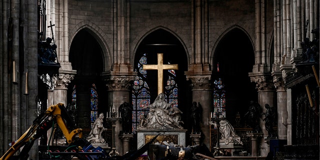 Rubble and the cross inside the Notre Dame de Paris Cathedral, Wednesday May 15, 2019 in Paris. French Culture Minister Franck Riester says that one month after a fire engulfed Notre Dame Cathedral, the edifice is still being made safe enough for restoration to begin.