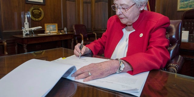 Alabama Gov. Kay Ivey signs a bill that virtually outlaws abortion in the state on Wednesday, May 15, 2019, in Montgomery. (Hal Yeager/Alabama Governor's Office via AP)