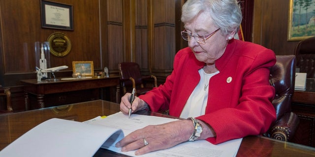 Alabama Gov. Kay Ivey signs a bill that virtually outlaws abortion in the state on Wednesday, May 15, 2019, in Montgomery. (Hal Yeager/Alabama Governor's Office via AP)