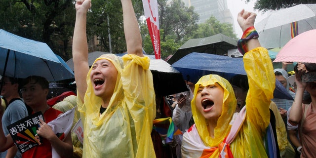 Same-sex marriage supporters cheer outside the Legislative Yuan in Taipei, Taiwan, on Friday, after Taiwan's legislature has passed a law allowing same-sex marriage in a first for Asia. (Associated Press)