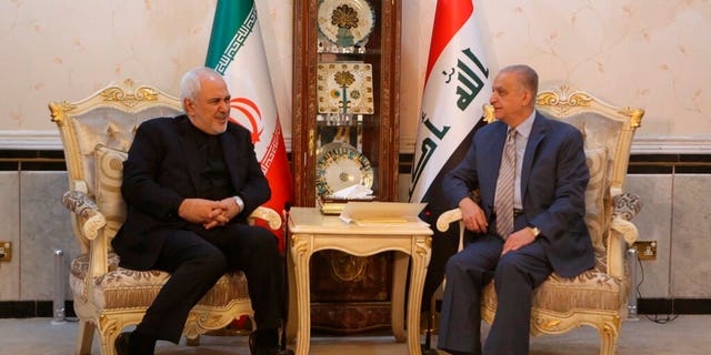 Iraqi Foreign Minister Mohamed Alhahkim, right, meets with his visiting Iranian counterpart Mohammad Javad Zarif at the Ministry of Foreign Affairs in Baghdad.