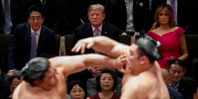 President Trump attends the Tokyo Grand Sumo Tournament with Japanese Prime Minister Shinzo Abe at Ryogoku Kokugikan Stadium, on Sunday, in Tokyo. First lady Melania Trump is at top right. (Associated Press)