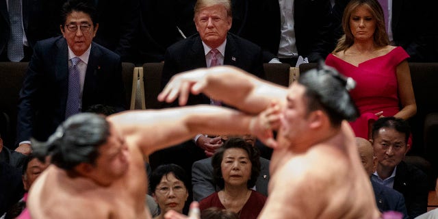 President Trump attends the Tokyo Grand Sumo Tournament with Japanese Prime Minister Shinzo Abe at Ryogoku Kokugikan Stadium, on Sunday, in Tokyo. First lady Melania Trump is at top right. (Associated Press)