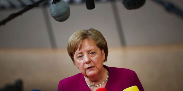 German Chancellor Angela Merkel speaks with the media as she arrives for an EU summit in Brussels, Tuesday, May 28, 2019.