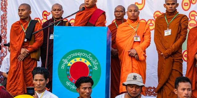 In this May 5, 2019, photo, Buddhist monk and anti-Muslim community leader Wirathu, center, speaks during a nationalist rally in Yangon, Myanmar.
