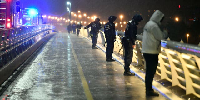 Rescuers and police officers at the scene from a landing dock in Budapest. (Zsolt Szigetvary / MTI via AP)