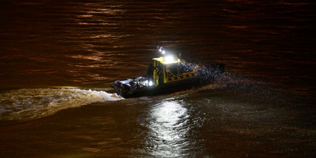A rescue boat searching for victims Wednesday night. (Zsolt Szigetvary / MTI via AP)