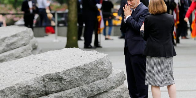 Comedian Jon Stewart talks with Alice Greenwald, CEO of the National September 11 Memorial & Museum, before the start of a dedication ceremony in New York on Thursday. Michael Bloomberg, former mayor, says the new memorial glade at the World Trade Center site "helps us fulfill our duty" to those who were sickened or died after responding to the Sept. 11 attacks. (AP Photo/Seth Wenig)