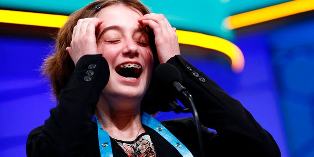 Colette Giezentanner, 12, from St. Louis, laughs as she takes to the finals of Scripps National Spelling Bee on Thursday. May 30, 2019 in Oxon Hill, Md.