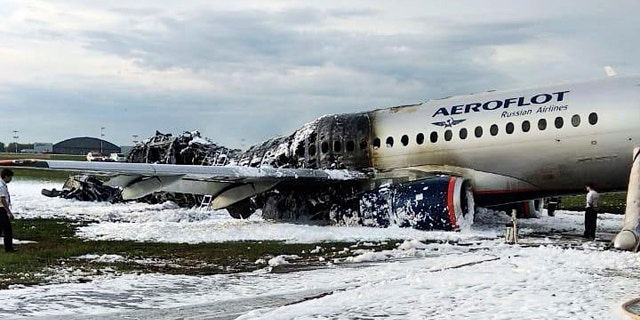 The Sukhoi SSJ100 aircraft of Aeroflot airlines is covered in fire retardant foam after an emergency landing in Sheremetyevo airport in Moscow, Russia, Sunday, May 5, 2019.