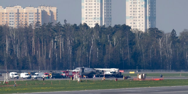The Sukhoi SSJ100 aircraft of Aeroflot Airlines, center in the background, is seen after an emergency landing in Sheremetyevo airport outside Moscow, Russia, Monday, May 6, 2019.