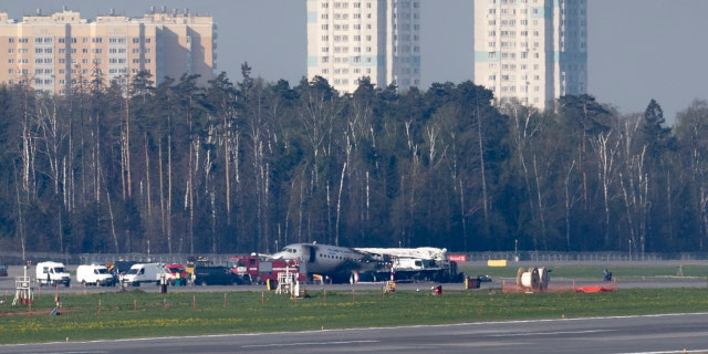 The Sukhoi SSJ100 aircraft of Aeroflot Airlines, center in the background, is seen after an emergency landing in Sheremetyevo airport outside Moscow, Russia, Monday, May 6, 2019.