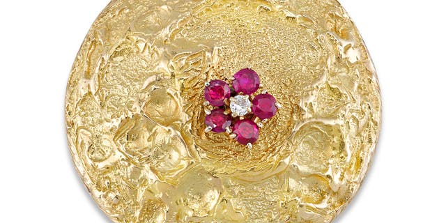 The brooch is shaped to resemble the lunar surface.