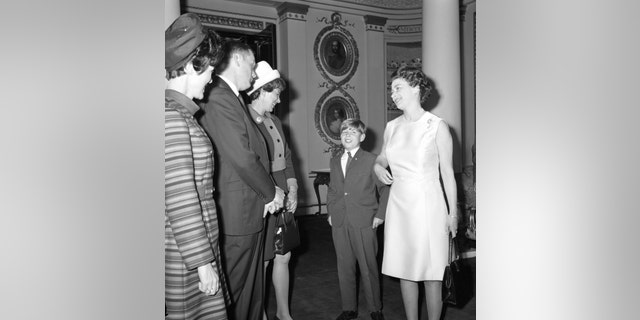 File photo - Queen Elizabeth II and Prince Andrew talk with Neil Armstrong, his wife Janet and Pat Collins, left, wife of Colonel Michael Collins, at Buckingham Palace. Janet Armstrong is wearing the lunar brooch on her lapel.
