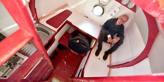 Jean-Jacques Savin shows the inside of the barrel that includes a bunk, kitchen and storage.