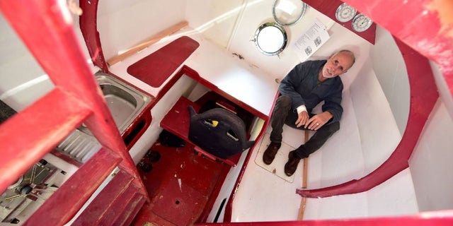 Jean-Jacques Savin shows the inside of the barrel that includes a bunk, kitchen and storage.