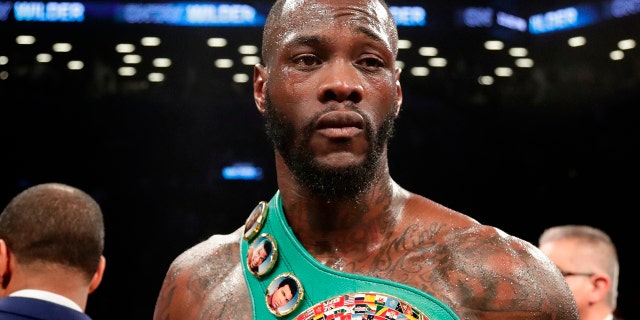 FILE - In this March 3, 2018, file photo, Deontay Wilder poses for photographs after the WBC heavyweight champion defeated Luis Ortiz in New York. (AP Photo/Frank Franklin II, File)