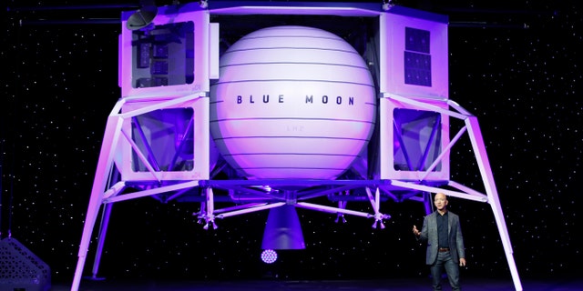 Jeff Bezos speaks in front of a model of Blue Origin's Blue Moon lunar lander, Thursday, May 9, 2019, in Washington D.C.. (AP Photo/Patrick Semansky)