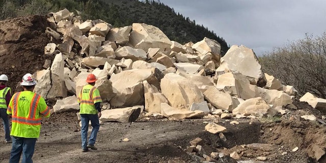 Rubble can be seen after a massive boulder was blasted into pieces after destroying a section of a highway in Colorado over the weekend.