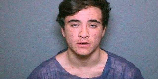 This undated booking photo provided by the Orange County District Attorney's Office shows Aquinas Kasbar, 19, of Newport Beach, Calif. (Orange County District Attorney's Office via AP)