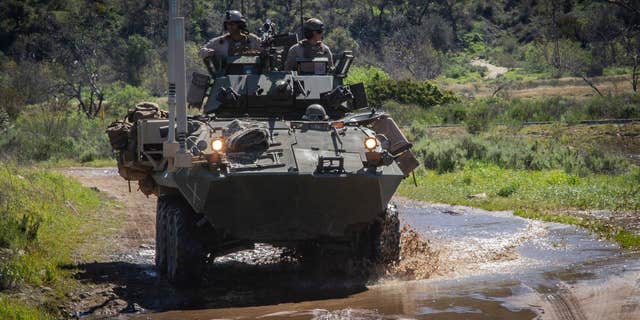 The Marines board an armored vehicle at Camp Pendleton located in northern San Diego County, Southern California.