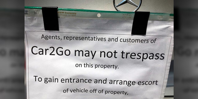 This undated photo provided by KOMO News shows a notice attached to a car-share vehicle parked at a Seattle duplex. (KOMO News via AP)